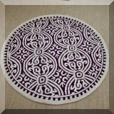DR08. Round purple and cream throw rug. 